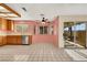 Bright kitchen with tile floors, stainless steel dishwasher, and window overlooking the backyard at 409 Rutherford Cir, Las Vegas, NV 89123