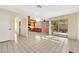 Open-concept living space with tile floors, access to the kitchen, and sliding glass doors to the patio at 409 Rutherford Cir, Las Vegas, NV 89123