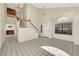 Spacious living room featuring tile floors, staircase, fireplace, and a bright sunny window at 409 Rutherford Cir, Las Vegas, NV 89123