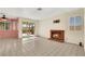View of the open living area featuring a fireplace, tile flooring, and access to the outdoor patio at 409 Rutherford Cir, Las Vegas, NV 89123