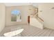 Living room boasting tile floors, tall ceilings, staircase, and a big window providing natural light at 409 Rutherford Cir, Las Vegas, NV 89123
