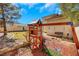 Backyard play structure includes swings and a playhouse with ample room for entertainment at 409 Rutherford Cir, Las Vegas, NV 89123