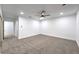 Well-lit bedroom with neutral carpet, ceiling fan, and white walls, creating a serene atmosphere at 4667 E Boston Ave, Las Vegas, NV 89104