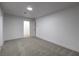 Neutral bedroom offering a minimalist interior with white walls and neutral carpet at 4667 E Boston Ave, Las Vegas, NV 89104