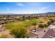 Scenic aerial view of a golf course community with mountain views, mature trees and desert landscaping at 4796 Riva De Romanza St, Las Vegas, NV 89135