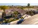Aerial view of a well-maintained home with lush landscaping and a three-car garage at 4796 Riva De Romanza St, Las Vegas, NV 89135
