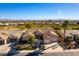 Expansive aerial view of a single story home with a tile roof situated on a golf course with mountain views at 4796 Riva De Romanza St, Las Vegas, NV 89135