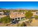 Expansive aerial view of a desert home with lush landscaping, a tiled roof, and mountain views at 4796 Riva De Romanza St, Las Vegas, NV 89135