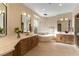 Beautiful bathroom featuring double sinks, a soaking tub, and a glass-enclosed shower at 4796 Riva De Romanza St, Las Vegas, NV 89135