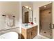 Elegant bathroom featuring a modern vanity, marble countertops, and a glass-enclosed shower at 4796 Riva De Romanza St, Las Vegas, NV 89135