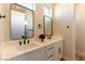 Modern bathroom with dual sinks, white cabinetry, and marble countertops at 4796 Riva De Romanza St, Las Vegas, NV 89135