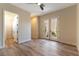 Spacious bedroom featuring wood floors, double doors to the outside, and ample natural light at 4796 Riva De Romanza St, Las Vegas, NV 89135