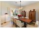 Charming dining room with a long wooden table, seating for six, and bright natural light at 4796 Riva De Romanza St, Las Vegas, NV 89135