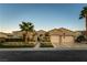 Inviting single-story home featuring a three-car garage, mature palm trees, and desert landscaping at 4796 Riva De Romanza St, Las Vegas, NV 89135
