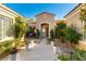 Beautifully landscaped front entrance with pavers and double glass front doors at 4796 Riva De Romanza St, Las Vegas, NV 89135