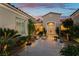 Close up of front entrance with pavers, double glass front doors, and potted flowers at 4796 Riva De Romanza St, Las Vegas, NV 89135