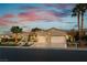 Charming single story home with desert landscaping, tall palm trees, and a three car garage at 4796 Riva De Romanza St, Las Vegas, NV 89135