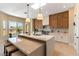 Modern kitchen featuring a large island, bar seating, stainless appliances, and custom cabinets at 4796 Riva De Romanza St, Las Vegas, NV 89135