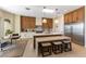 Gourmet kitchen with a center island, breakfast bar, stainless steel appliances, and custom cabinetry at 4796 Riva De Romanza St, Las Vegas, NV 89135