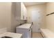 Bright laundry room features white cabinets, a bench, and modern washer and dryer at 4796 Riva De Romanza St, Las Vegas, NV 89135