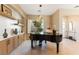 Elegant living room featuring a grand piano, custom built-ins, and an abundance of natural light from the large window at 4796 Riva De Romanza St, Las Vegas, NV 89135