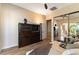 Cozy living room featuring built-in shelving and sliding glass doors to the patio at 4796 Riva De Romanza St, Las Vegas, NV 89135