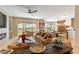 Bright living room featuring comfortable sofas, an open floor plan, and sliding doors to the backyard at 4796 Riva De Romanza St, Las Vegas, NV 89135