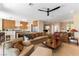 Spacious open-concept living room with a combined kitchen, plush sofas, and comfortable seating at 4796 Riva De Romanza St, Las Vegas, NV 89135