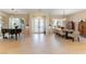 Spacious living and dining space featuring large tiles, shutters, and neutral paint at 4796 Riva De Romanza St, Las Vegas, NV 89135