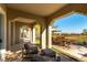 Covered patio featuring comfortable seating and views of the backyard and golf course at 4796 Riva De Romanza St, Las Vegas, NV 89135
