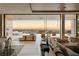 Open-concept living room with modern décor, hardwood floors, and access to a balcony overlooking the backyard at 4918 Summit Overlook Dr, Las Vegas, NV 89135