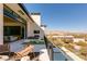 Outdoor balcony with a seating area and stunning views of the surrounding landscape and mountains at 4918 Summit Overlook Dr, Las Vegas, NV 89135