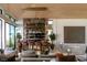 Stylish bar area with stone accents, modern shelving, and comfortable seating in a luxury home at 4918 Summit Overlook Dr, Las Vegas, NV 89135