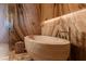 Close-up of standalone stone tub with gold fixtures in luxurious primary bathroom at 4918 Summit Overlook Dr, Las Vegas, NV 89135