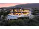 Stunning two-story home featuring an in-ground pool, luxurious outdoor seating, and a captivating mountain view at 4918 Summit Overlook Dr, Las Vegas, NV 89135