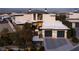 Modern home with a manicured front yard and a two-car garage featuring sleek doors with glass inserts at 4918 Summit Overlook Dr, Las Vegas, NV 89135