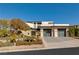 Modern home with a manicured front yard, desert landscaping, and a two-car garage at 4918 Summit Overlook Dr, Las Vegas, NV 89135