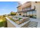 Home exterior showcasing outdoor terraces, fire feature, and glass railings at 4918 Summit Overlook Dr, Las Vegas, NV 89135