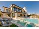 Luxury home exterior with a pool, lounge area, and dining space at 4918 Summit Overlook Dr, Las Vegas, NV 89135