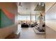 Bright foyer with contemporary art, hardwood floors, and a modern staircase with access to the living space at 4918 Summit Overlook Dr, Las Vegas, NV 89135