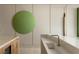 Modern kitchen island with white countertop and artistic green circle on the wall at 4918 Summit Overlook Dr, Las Vegas, NV 89135