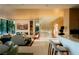 Open-concept living room with modern décor, hardwood floors, and a staircase with a glass railing at 4918 Summit Overlook Dr, Las Vegas, NV 89135