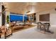 Open living space with a stone bar, comfortable seating, and stunning views at 4918 Summit Overlook Dr, Las Vegas, NV 89135