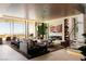 Open-concept living room featuring a fireplace, hardwood floors, modern decor, and access to a balcony at 4918 Summit Overlook Dr, Las Vegas, NV 89135