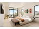 Bright main bedroom featuring modern decor, neutral tones, and expansive windows showcasing a beautiful view at 4918 Summit Overlook Dr, Las Vegas, NV 89135