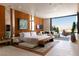 Spacious main bedroom with a view, contemporary furniture, and wood paneled accent wall at 4918 Summit Overlook Dr, Las Vegas, NV 89135