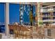 Close-up view of a home wet bar with stylish stools and city views at night at 4918 Summit Overlook Dr, Las Vegas, NV 89135