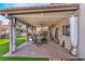 Covered back patio featuring outdoor seating and well manicured lawn at 4938 Via Luis Ct, North Las Vegas, NV 89031