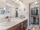 Bright bathroom featuring dual sinks, modern fixtures, and a walk-in closet at 4938 Via Luis Ct, North Las Vegas, NV 89031