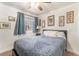 Bedroom with light blue comforter, ceiling fan, and bright window at 4938 Via Luis Ct, North Las Vegas, NV 89031